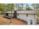 Rear view of a white brick house with a deck and wooded setting at 2228 Old Dallas Sw Rd, Marietta, GA 30064