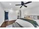 Main bedroom with dark hardwood floors, a ceiling fan, and an attached bathroom at 2228 Old Dallas Sw Rd, Marietta, GA 30064