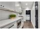 Modern kitchen with white cabinets, quartz countertops, and hardwood floors at 2228 Old Dallas Sw Rd, Marietta, GA 30064