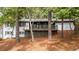 White brick house with a gray deck, nestled in a wooded area at 2228 Old Dallas Sw Rd, Marietta, GA 30064