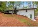 Rear view of a white brick house with a deck and wooded setting at 2228 Old Dallas Sw Rd, Marietta, GA 30064