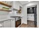 Modern kitchen with white cabinets, wooden shelves, and stainless steel appliances at 2228 Old Dallas Sw Rd, Marietta, GA 30064
