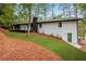 Rear view of a white brick house with a deck and wooded setting at 2228 Old Dallas Sw Rd, Marietta, GA 30064