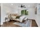 Well-lit bedroom featuring a comfortable bed, dark hardwood floors, and a ceiling fan at 2228 Old Dallas Sw Rd, Marietta, GA 30064