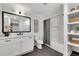 Modern bathroom with white vanity, bathtub, and built-in shelving at 2228 Old Dallas Sw Rd, Marietta, GA 30064
