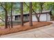 White brick house with a gray deck, nestled in a wooded area at 2228 Old Dallas Sw Rd, Marietta, GA 30064