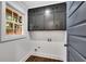 Laundry room with dark gray cabinets and hardwood floors at 2228 Old Dallas Sw Rd, Marietta, GA 30064