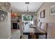 Dining room with a long wooden table and access to the kitchen and deck at 4693 Hairston Crossing Rd, Stone Mountain, GA 30083