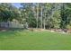 Large backyard with wooden footbridge and trees at 4693 Hairston Crossing Rd, Stone Mountain, GA 30083