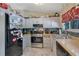 Galley kitchen with stainless steel appliances and light grey cabinets at 4693 Hairston Crossing Rd, Stone Mountain, GA 30083
