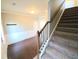 Hardwood floor entryway with staircase and coat hooks at 2414 Allsborough Way, Dacula, GA 30019