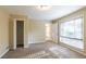 Bright bedroom with window, closet, and neutral decor at 4323 Autumn Hill Dr, Stone Mountain, GA 30083