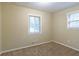 Simple bedroom with two windows and neutral walls at 4323 Autumn Hill Dr, Stone Mountain, GA 30083