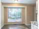 Bright dining area with large window and wood-look flooring at 4323 Autumn Hill Dr, Stone Mountain, GA 30083