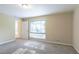 Well-lit bedroom with window and access to hallway at 4323 Autumn Hill Dr, Stone Mountain, GA 30083