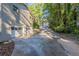 Attached garage with driveway leading to wooded area at 4323 Autumn Hill Dr, Stone Mountain, GA 30083