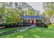 Ranch home features a red front door and nicely landscaped yard at 4323 Autumn Hill Dr, Stone Mountain, GA 30083