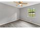 Well-lit bedroom with a window and ceiling fan at 3756 Ferncliff Rd, Snellville, GA 30039