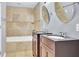 Main bathroom with double vanity, soaking tub and tile surround at 3225 Fern Dr, Tucker, GA 30084