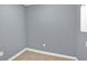 Empty, gray-walled basement room with tile floor at 3225 Fern Dr, Tucker, GA 30084