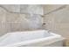 Bathroom with a large corner soaking tub and tile surround at 3225 Fern Dr, Tucker, GA 30084