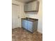 Small kitchen with double sink, gray cabinets, and brown tile floor at 226 Stayman Dr, Riverdale, GA 30274