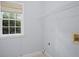 Bright laundry room with built-in shelving and window at 11385 Quailbrook Chase, Johns Creek, GA 30097