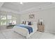 Bright bedroom featuring a king-size bed and tray ceiling at 11385 Quailbrook Chase, Johns Creek, GA 30097