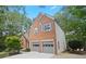 Two-story home with two car garage and mature trees at 11385 Quailbrook Chase, Johns Creek, GA 30097