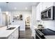 Bright kitchen with white cabinets, a large island, and walk-in pantry at 3351 Orwell Way # 2105, Cumming, GA 30041