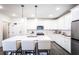 Modern kitchen with white cabinets, quartz countertops, and stainless steel appliances at 3351 Orwell Way # 2105, Cumming, GA 30041
