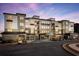 Luxury apartment building with stone and metal accents at dusk at 3351 Orwell Way # 2105, Cumming, GA 30041