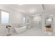 Luxurious bathroom with soaking tub, walk-in shower, and marble flooring at 2635 Camp Branch Rd, Buford, GA 30519