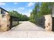 Private gated entrance with brick pavers and lush landscaping at 2635 Camp Branch Rd, Buford, GA 30519
