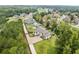 Aerial view of a modern home in a tree-lined neighborhood with gated entrance and pool at 2635 Camp Branch Rd, Buford, GA 30519