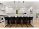 Modern kitchen with white cabinets, marble countertops, and breakfast bar with black stools at 2635 Camp Branch Rd, Buford, GA 30519