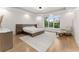Bright bedroom with hardwood floors and a large window at 2635 Camp Branch Rd, Buford, GA 30519