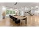 Bright dining room with long wood table and black velvet chairs, open to living room at 2635 Camp Branch Rd, Buford, GA 30519