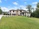 Luxury home with a large lawn and a gated entrance at 2635 Camp Branch Rd, Buford, GA 30519