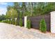 Privacy fence with dark wood, white brick, and manicured greenery at 2635 Camp Branch Rd, Buford, GA 30519