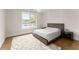 Bright bedroom with wood floors, large window, and modern bed at 2635 Camp Branch Rd, Buford, GA 30519