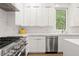 Modern white kitchen with marble countertops and stainless steel appliances at 2635 Camp Branch Rd, Buford, GA 30519