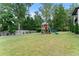 Large backyard with playset and trampoline at 2635 Camp Branch Rd, Buford, GA 30519
