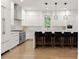 Modern kitchen with white cabinets, marble countertops and island with breakfast bar at 2635 Camp Branch Rd, Buford, GA 30519