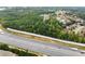 Aerial view of a large lot next to a highway with a sound barrier wall, adjacent to a residential neighborhood at 2635 Camp Branch Rd, Buford, GA 30519