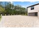 Expansive brick paver driveway leading to a modern garage at 2635 Camp Branch Rd, Buford, GA 30519