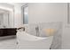 Luxurious bathroom with a modern freestanding bathtub and marble accents at 2635 Camp Branch Rd, Buford, GA 30519