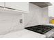 Modern kitchen details featuring marble countertops and gas cooktop at 2635 Camp Branch Rd, Buford, GA 30519