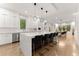 Modern kitchen with white cabinets, marble countertops and island with breakfast bar at 2635 Camp Branch Rd, Buford, GA 30519
