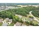 Aerial view showcasing a modern home nestled in a wooded area near a highway at 2635 Camp Branch Rd, Buford, GA 30519